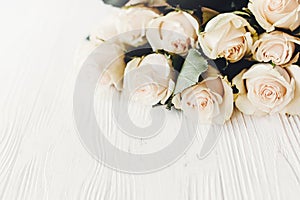 Floral greeting card mockup. White roses on wooden background, s