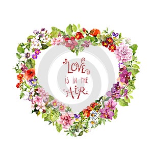 Floral heart shape, motivate quote Love is in the air . Summer flowers, meadow herbs, wild grass. Watercolor for