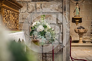 Floral ornamentation inside a worship space, church. Flower arrangements predominantly white and green