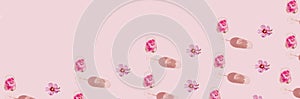 Floral pattern banner made of glass with hibiscus flower water on pastel pink background. Minimal style. Summer refreshment