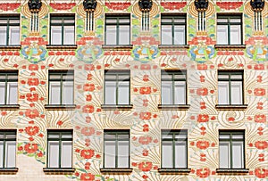 Floral patterns on front of historical buildng with windows, center of Vienna, Austria