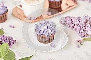 Floral purple cake in trending Dreamy Escapism. Leisure and relax coffee time. Spring purple background. Beautiful food photo