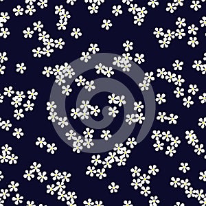 Floral seamless pattern with small white daisy flowers on dark blue background. Ditsy print. Plain chamomile florets