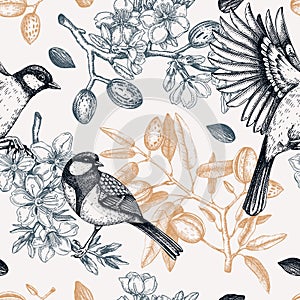 Floral spring garden seamless pattern. Birds on almond branches vintage background design. Great tit with blooming twigs, nuts,