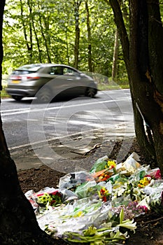 Floral Tributes At Scene Of Fatal Accident On Busy Road With Speeding Car