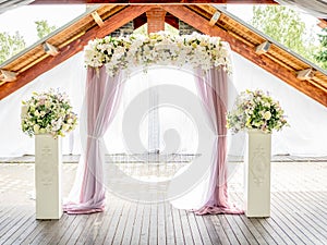 Floral wedding arch of roses and lillies