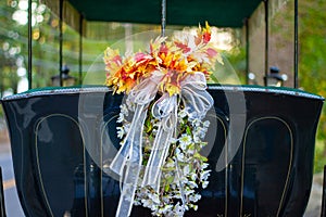 Floral wedding bouquet on the back of a carriage