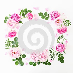 Floral wreath frame made of pink roses and peonies with green leaves on white background. Flat lay, top view. Flower background