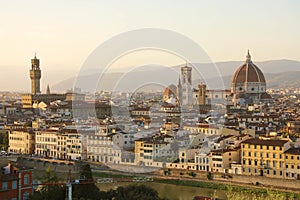 Florence city during golden sunset. Panoramic view of the river Arno with Palazzo Vecchio palace and Cathedral of Santa Maria del