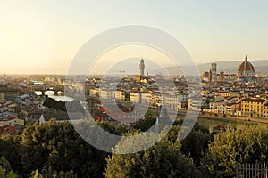 Florence city during golden sunset. Panoramic view of the river Arno with Ponte Vecchio bridge, Palazzo Vecchio palace and