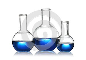 Florence flasks with liquid samples on white. Chemistry glassware