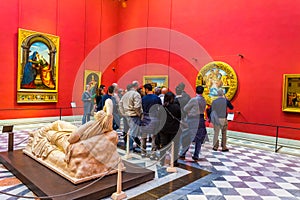 FLORENCE, ITALY, MARCH 15, 2016: Doni Tondo statue by Michelangelo is situated in the red room of the uffizi gallery in