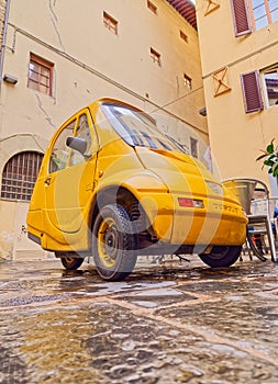 Parked electric car Pasqali in narrow street in Florence Italy