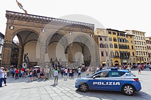 Florence, ITALY- September 10, 2016: Police car patrols on the Square of Signoria and near Loggia dei Lanzi in Florence