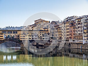 Florence in Italy in winter sunshine. The River Arno and part of the famous Ponte Vechio, Old Bridge, with