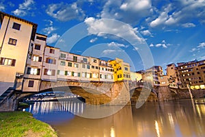 Florence, Italy. Wonderful sunset above Magnificent Ponte Vecchio - Old Bridge view from Arno river bank