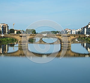 Florenceâ€™s Ponte Santa Trinita reflected in the water of the Arno river