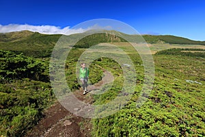 Young woman trekking on Flores Island, Azores photo