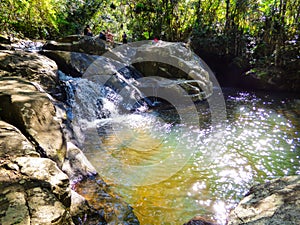 People enjoying a sunny day at Serta do Ribeirao Waterfall photo