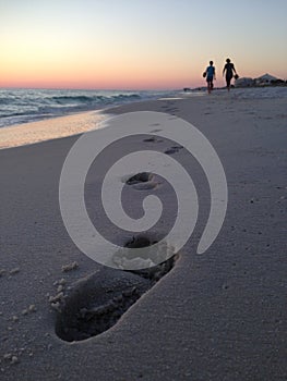 Florida Beach Sunset with People and Footprints in Sand