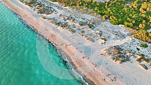 Florida Blind Pass beach with soft white sand on Manasota Key, USA. People enjoying vacation time bathing in warm gulf