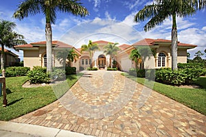 Florida luxury home with paver block driveway