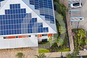 Florida office building with solar roof. Blue photovoltaic panels for producing clean ecological electric energy