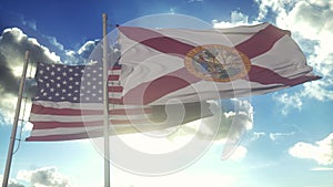 Florida state flags waving along with the national flag of the United States of America. In the background there is a