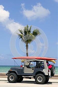 Florida surfer car with surfboard blue sky