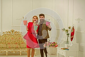 Florist concept. Happy woman and man florists smile with spring flowers. Florist shop. Florists in flower shop. Experts