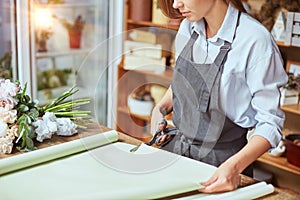 Florist cutting wrapping paper for fresh bouquet