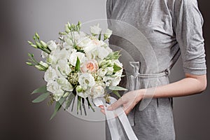 Florist girl with rich bunch flowers. Fresh spring bouquet. Summer Background. Young woman flower for birthday or mother