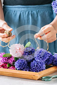Florist girl tieing bouquet of hyacinth flowers. Flower s