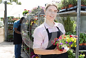 Florist girl working in greenhouse