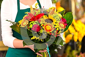 Florist holding bouquet colorful flowers shop assistant