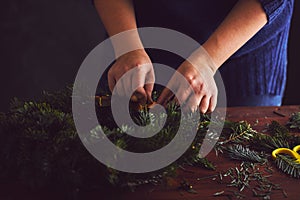 Florist makes a traditional Christmas wreath