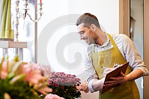 Florist man with clipboard at flower shop