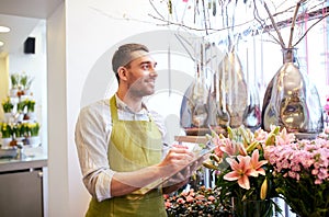 Florist man with clipboard at flower shop