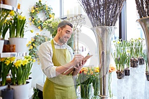 Florist man with clipboard at flower shop