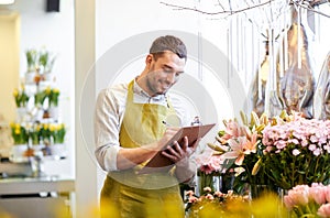 Florist man with clipboard at flower shop