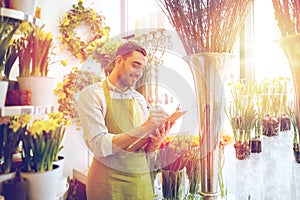 Florist man with clipboard at flower shop