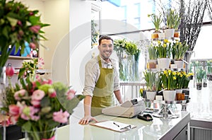 Florist man with clipboard at flower shop counter photo