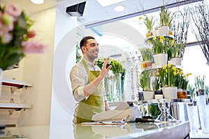 Florist man or seller at flower shop counter