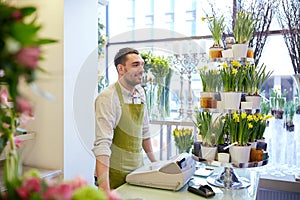 Florist man or seller at flower shop counter