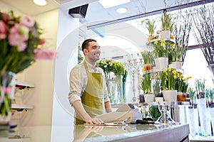 Florist man or seller at flower shop counter