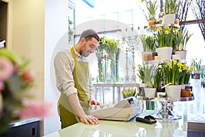 Florist man or seller at flower shop counter