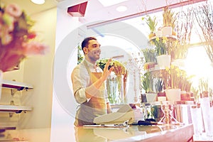 Florist man or seller at flower shop counter