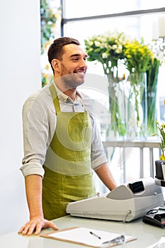 Florist man or seller at flower shop counter