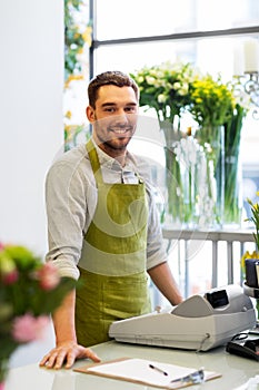 Florist man or seller at flower shop counter