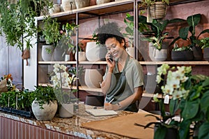 Florist takes an order on the phone at flower shop